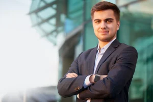 Portrait of a man in a suit against the building with a glass facade